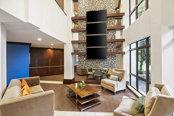 Modern lobby with transit screen and seating areas 